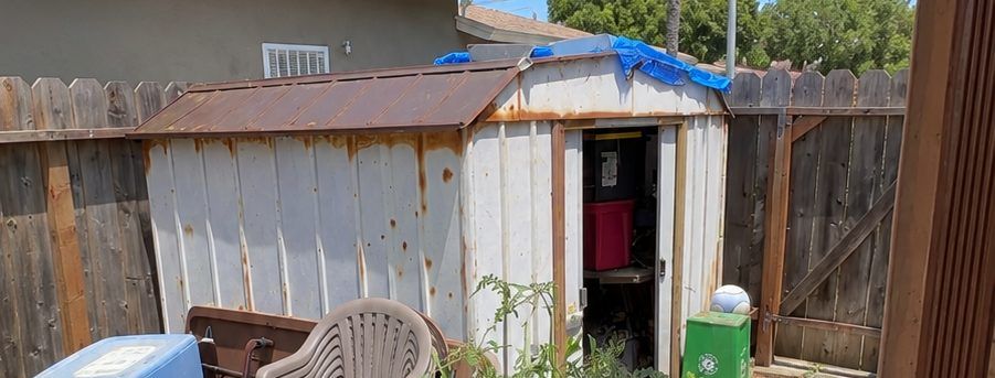 Old junk-filled shed before demolition