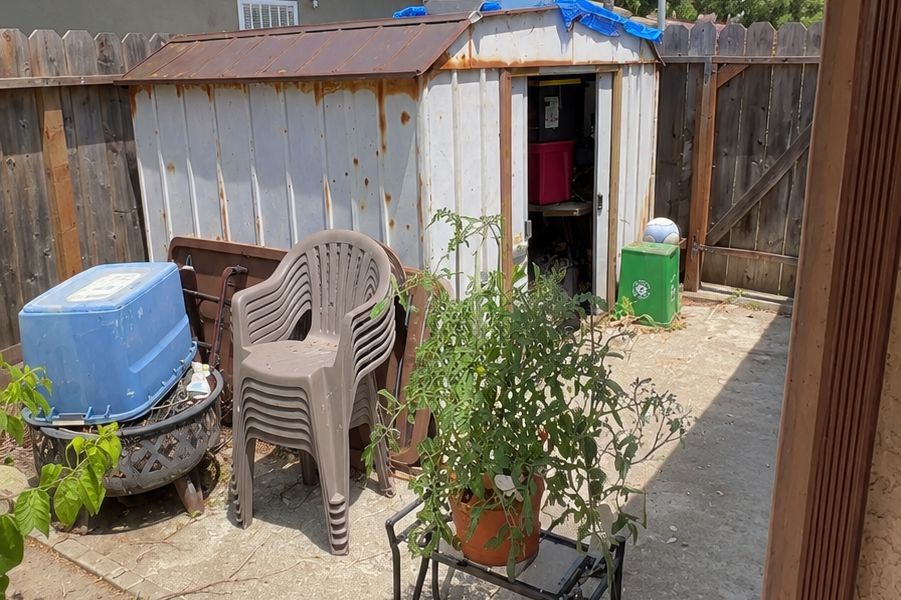 Old backyard shed packed with junk before removal